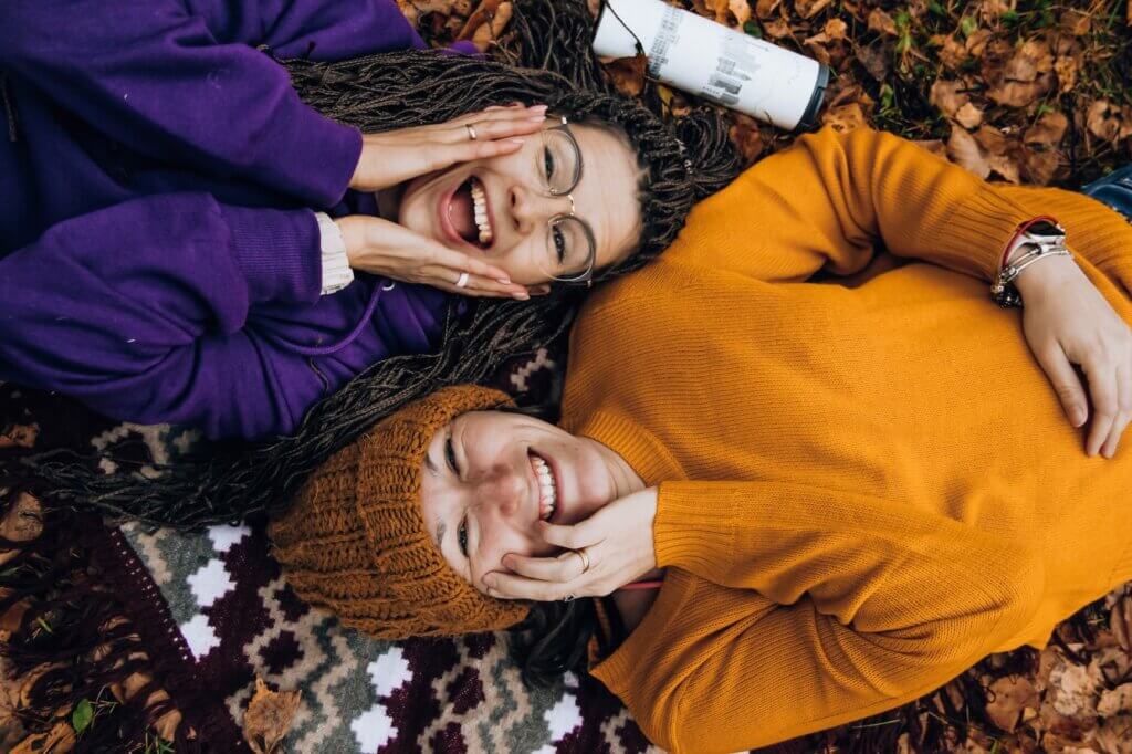 Girls laying on the ground smiling