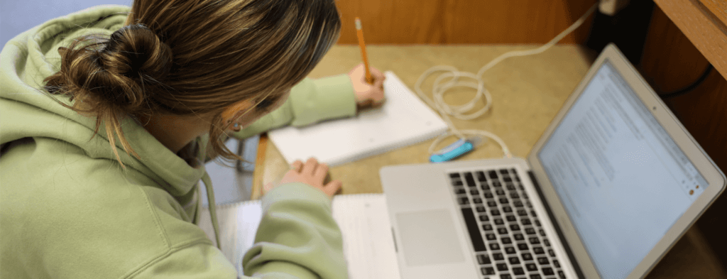 NHTI student working on a laptop