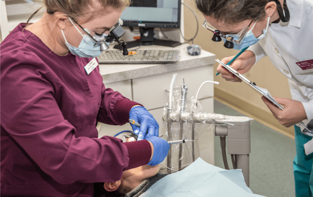 NHTI dental students work on patient.
