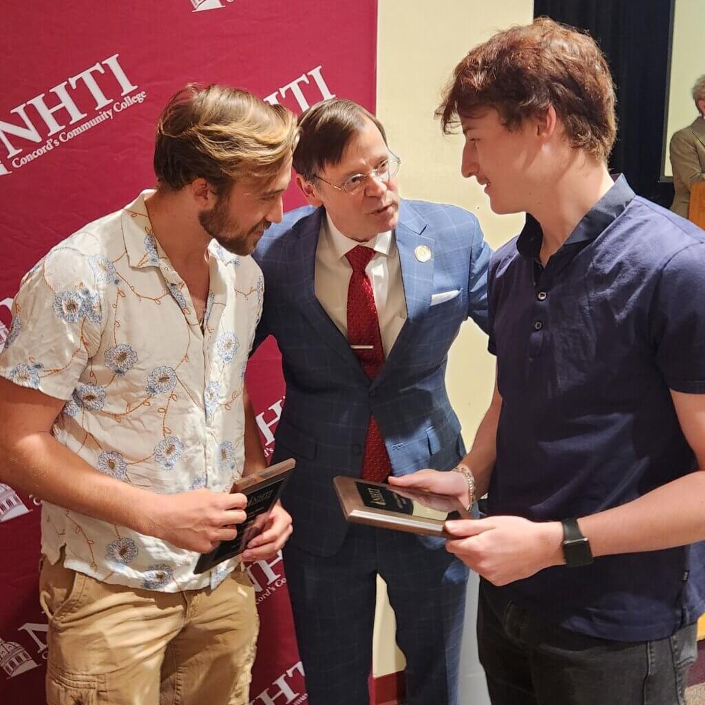 President Tompkins talking with students at award ceremony