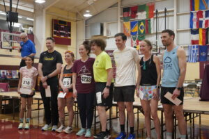 Race winners stand on stage in a row