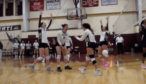 NHTI volleyball team cheers after a win